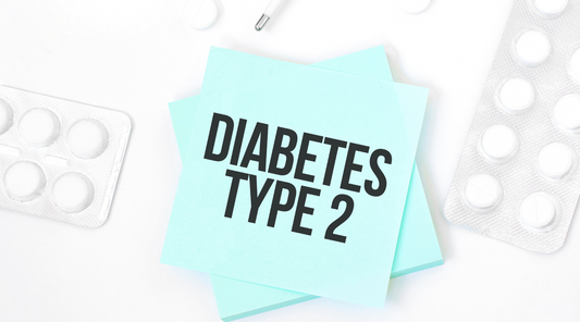 Blue card with text DIABETES TYPE 2 on a table with pills