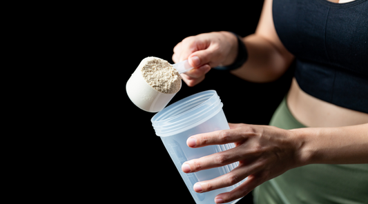 Woman Measuring Scoop of Protein powder and Shake