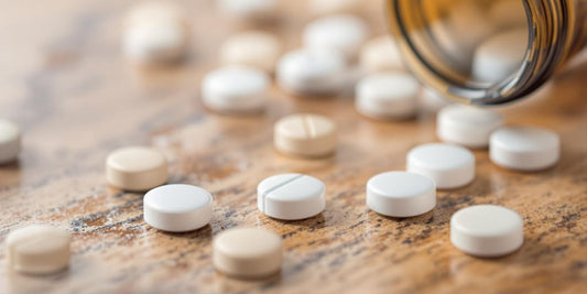 Atomoxet pills on a wooden surface.
