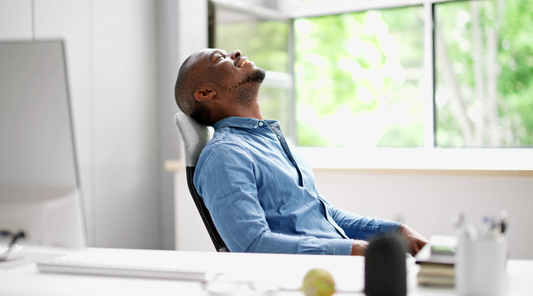 Happily breathing man at workplace.