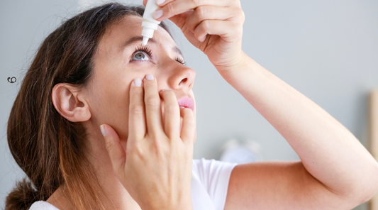 Young woman putting Careprost Plus eye drops