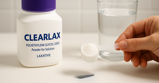 Hand measuring Clearlax powder scoop next to water glass