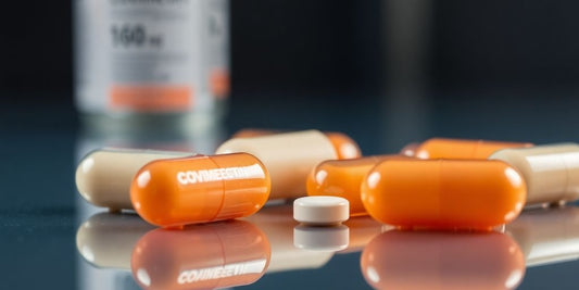 Covimectin capsules on reflective surface.